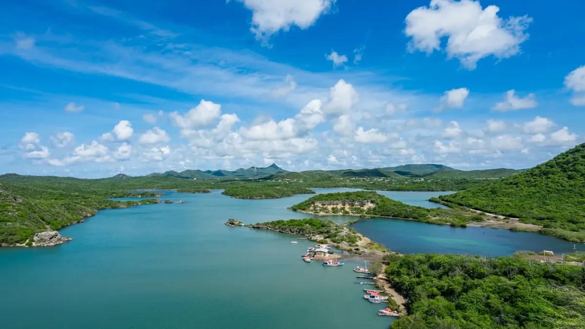 Beautiful island lagoon surrounded by lush green hills in the Caribbean